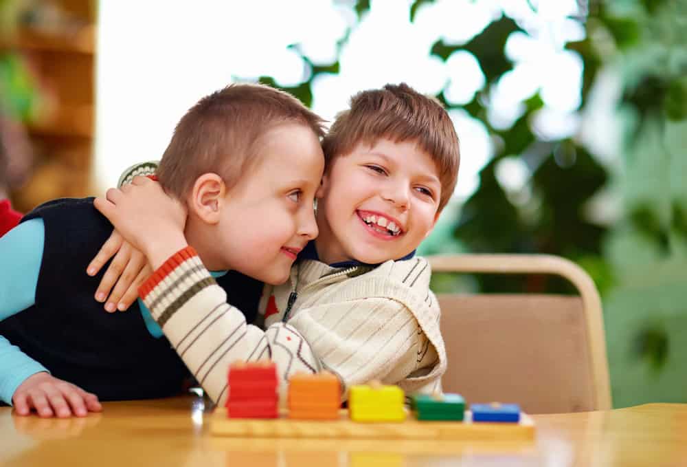 example of positive behaviour support with Karma Care. Photo of two happy boys